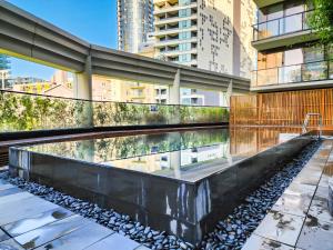a pool of water in the middle of a building at Modern 2-bedrooms apartment with parking in Melbourne