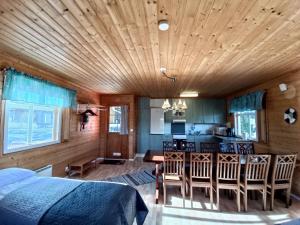a bedroom with a bed and a dining room and kitchen at Saaristotila Jackois in Iniö