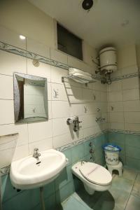 a bathroom with a sink and a toilet at Malhotra Guest House 50 Meter from Golden Temple in Amritsar