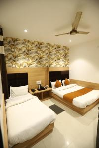 a bedroom with two beds and a ceiling at Malhotra Guest House 50 Meter from Golden Temple in Amritsar