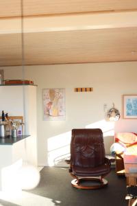 een leren stoel in een kamer met een bureau bij Hasselvnget 16, 5450 Otterup in Otterup