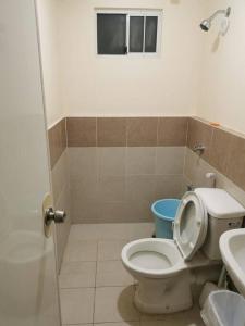 a bathroom with a toilet and a sink at Kate's Studio Unit in Davao City