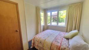 un dormitorio con una cama y una ventana en 22c Scarborough Tce, en Hanmer Springs