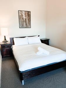 a bedroom with a bed with two towels on it at Central Hotel Stroud in Stroud