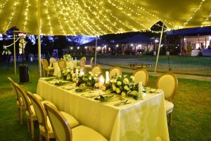 a table set up for a wedding with lights at Lake Elmenteita Serena Camp in Elmenteita