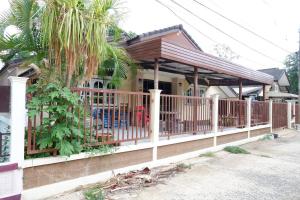 a house with a porch with a fence at บ้านใจกลางเมืองศรีสะเกษ 3นอน2น้ำ in Si Sa Ket