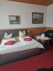 a bedroom with a bed with red pillows on it at Pension Zur Elbe in Lutherstadt Wittenberg