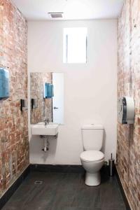 a bathroom with a toilet and a sink at Bayside House in Melbourne