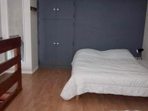 a bedroom with a white bed and a blue wall at Duplex avec balcon à 2 min de la plage - FR-1-482-103 in Fort-Mahon-Plage