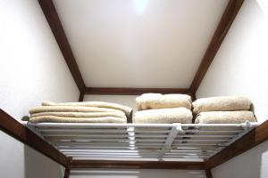 a bunch of towels on a shelf in a room at 海と湖が近い一軒家　”民泊あばしりの家” in Kitahama +42 photos