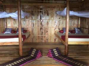 Postel nebo postele na pokoji v ubytování Robinson Bungalows