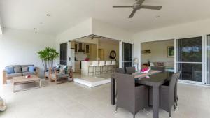 CraiglieCascade Links Port Douglas的用餐室和带吊扇的客厅