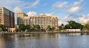 a large building next to a river with buildings at Water Street Retreat 14 in Wilmington