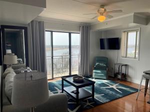 a living room with a view of the ocean at Water Street Retreat 04 in Wilmington