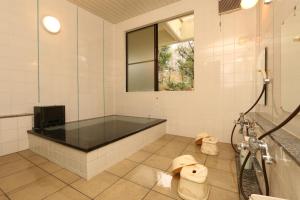 a bathroom with a shower and two toilets at Teiensaryo Yamanakako in Yamanakako