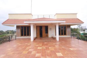 a small house with a red roof at royal stay in Madurai