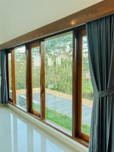 a window with a view of a patio at Batur Exotic Villa in Kubupenlokan