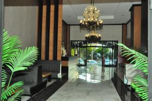 a lobby with a chandelier and some plants at Side Yeşilöz Hotel in Side