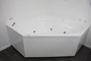 a white desk in a room with white walls at Camelot On Ulster in Hamilton