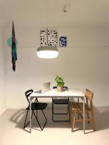 a white dining room table with a laptop on it at busan UA Stay House 우아 스테이 in Busan