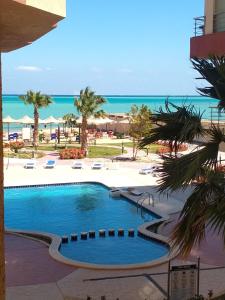 a swimming pool with the ocean in the background at كذا بلانكا بيتش 220 in Hurghada