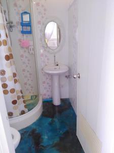 a bathroom with a sink and a mirror at บ้านอังกาบ Aungkab homestay in Ban Muang Len