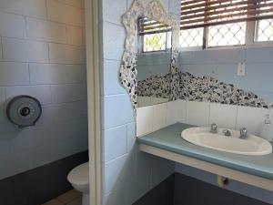 a bathroom with a sink and a toilet at Mission Beach Retreat in Mission Beach
