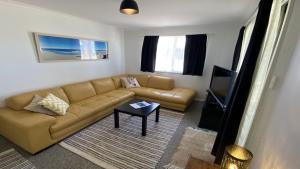a living room with a couch and a tv at Blue Marlin in Jurien Bay