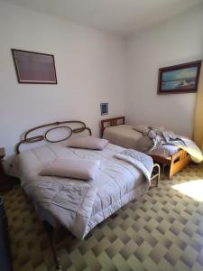 Posteľ alebo postele v izbe v ubytovaní dal pescatore appartamenti