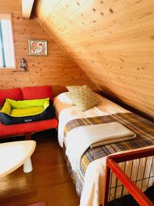 a bedroom with two beds in a attic at 1組限定ドッグフレンドリー&イギリス料理 Laughing dogs villa in Takashima