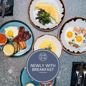 a table with plates of breakfast food on it at OREA Place Seno in Prague