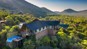an aerial view of a house in the mountains at Babohi at Qwabi Private Game Reserve by NEWMARK in Bela-Bela