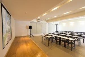 a room with rows of tables and chairs in a classroom at Sunshine Paradise Resort in Ban Krut