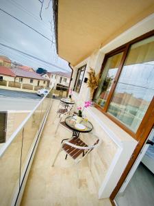 a balcony of a house with a table and chairs at IANIS Rooms in Mangalia