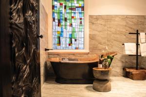 a bathroom with a tub and a stained glass window at Circa 1928 in Albury