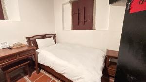 Postel nebo postele na pokoji v ubytování 銃樓民宿 Kinmen gunhouse