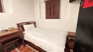 Postel nebo postele na pokoji v ubytování 銃樓民宿 Kinmen gunhouse