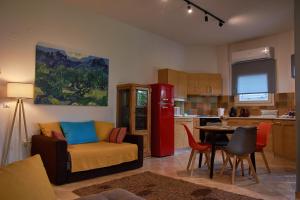 a kitchen with a couch and a table in a room at Iraklitsa View in Iraklitsa