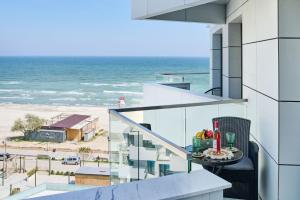 een balkon met uitzicht op de oceaan bij AdeMar Luxury Apartment- Spa&Pool Beach Resort in Mamaia