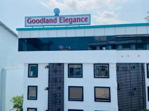 a building with a sign on top of it at Goodland Elegance in Trivandrum