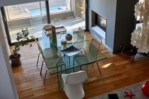 a dining room with a glass table and chairs at Magnificent, Deluxe Villa, Lagonisi, Athens Riviera in Áyios Nikólaos