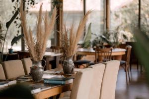 a dining room with a table with chairs and plants at TurkuazKöy in Finike