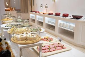 a buffet with many different types of food on display at LOTTE City Hotels Tashkent Palace in Tashkent +67 photos