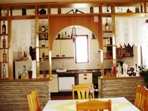 a kitchen with a table and an archway in it at Pansion Izvor in Korenica