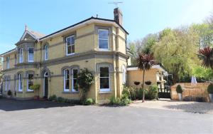 a large house with a driveway in front of it at Foxhills of Shanklin in Shanklin