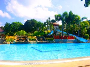 a swimming pool with a slide in a resort at Bakasyunan Resort and Conference Center - Zambales in Iba