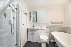 a bathroom with a sink and a toilet and a tub at Urquhart Bay Croft in Drumnadrochit +19 photos