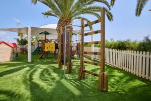 a playground with a slide and a play structure at Sunrise Oasis Hotel & Waterpark in Protaras