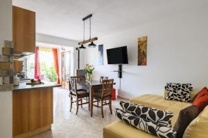 a kitchen and living room with a table and chairs at Villa Isabel in Cala Gonone