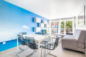 ein Wohnzimmer mit einem Tisch, Stühlen und einem Sofa in der Unterkunft Seimar 1-8 Apartment Levante Beach in Benidorm